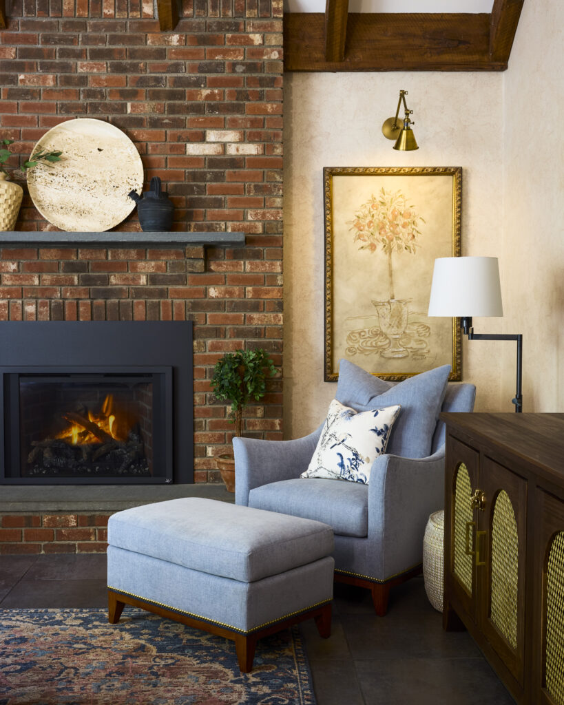 Cozy living room corner showcasing intimacy in interior design with task lighting, warm colors, and inviting textures. The soft lighting, plush cushions, and rich hues create a comfortable and intimate atmosphere perfect for relaxation.