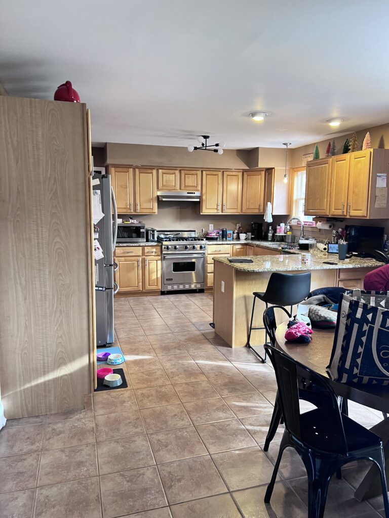 Before image of a kitchen with outdated cabinetry, cramped layout, and worn finishes, awaiting a custom design transformation by Jennifer Lynn Interiors.