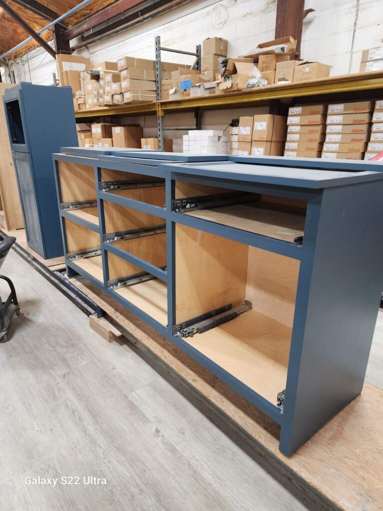 Crafting custom dark blue cabinetry for a kitchen remodel, highlighting the detailed craftsmanship and design process by Jennifer Lynn Interiors.