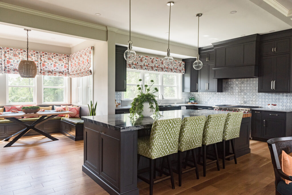 Bright kitchen with navy cabinets and green stools showing how interior design affects your mood