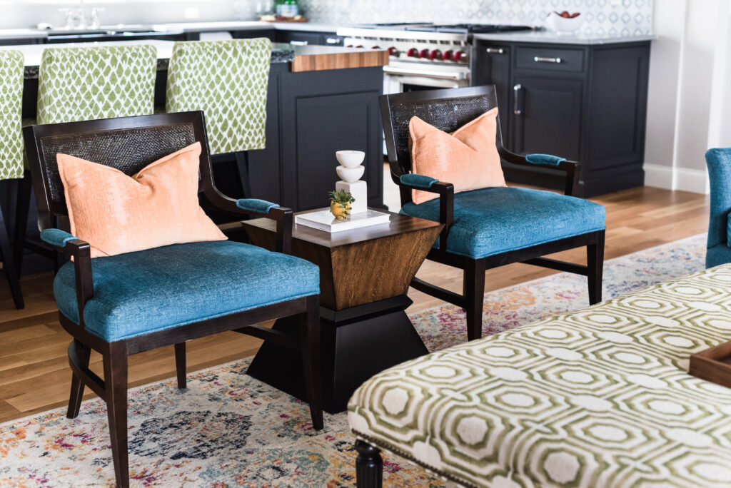 Cozy seating area with velvet chairs and textured rug illustrating how interior design affects your mood.