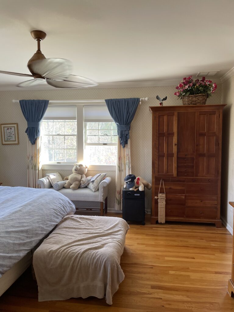 Before view of a primary bedroom showing natural light, empty walls, and an unlayered layout.
